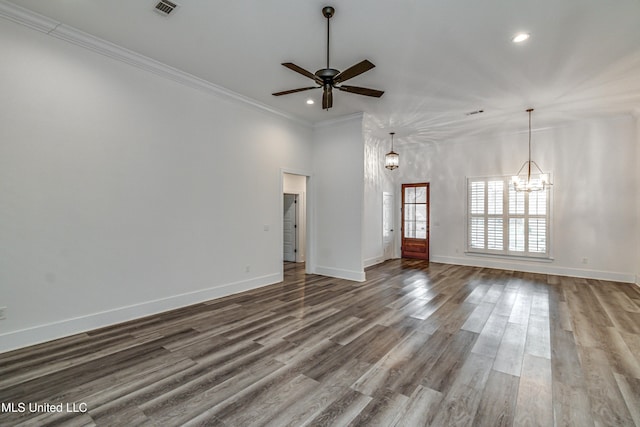 unfurnished living room featuring ceiling fan with notable chandelier, hardwood / wood-style floors, and crown molding