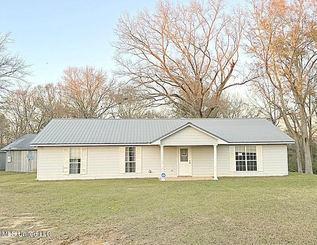 back of house with a lawn