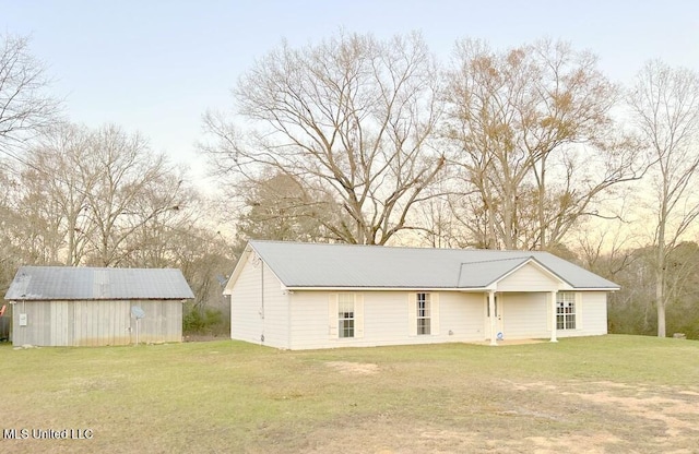 view of outdoor structure with a lawn