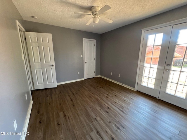 540 Woodland Hills Pl, Jackson, MS 39216 - unfurnished bedroom featuring access to outside, a textured ceiling, french doors, baseboards, and dark wood-style flooring