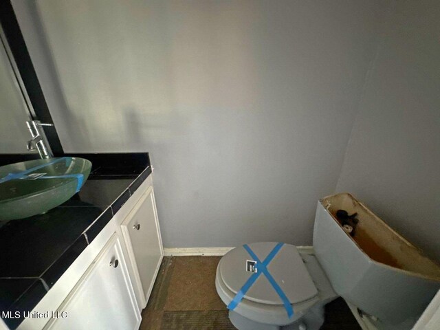 540 Woodland Hills Pl, Jackson, MS 39216 - bathroom with vanity, toilet, and baseboards