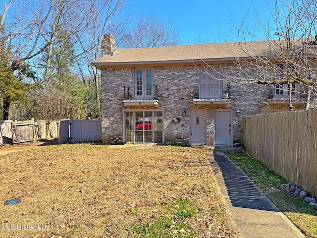 540 Woodland Hills Pl, Jackson, MS 39216 - traditional-style home featuring brick siding, a balcony, a chimney, and fence