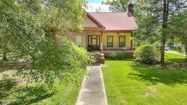 2548 Furrs Mill Dr, Wesson, MS 39191 - view of front of house featuring covered porch, a chimney, a front lawn, board and batten siding, and brick siding