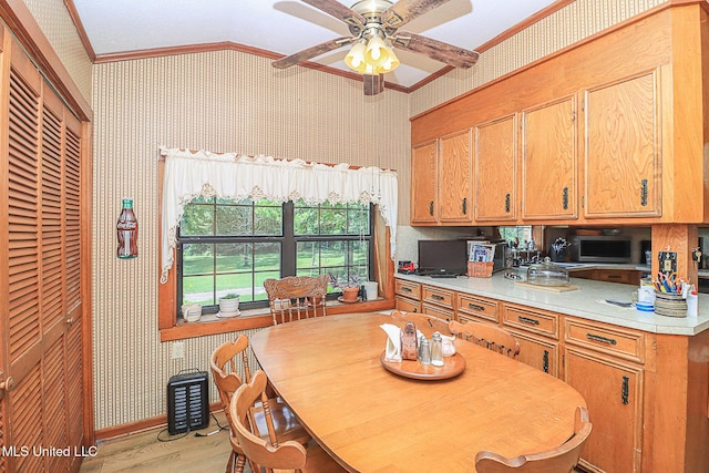 2548 Furrs Mill Dr, Wesson, MS 39191 - kitchen featuring crown molding, wallpapered walls, vaulted ceiling, light countertops, and a ceiling fan