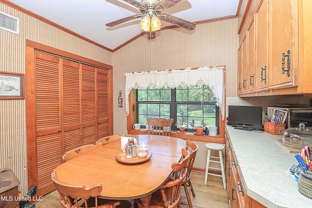 2548 Furrs Mill Dr, Wesson, MS 39191 - dining area featuring crown molding, wallpapered walls, a ceiling fan, light wood-style flooring, and vaulted ceiling