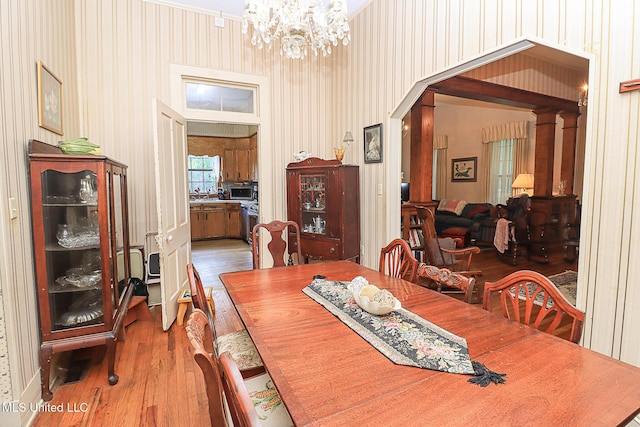 2548 Furrs Mill Dr, Wesson, MS 39191 - dining area featuring wood finished floors, a chandelier, and ornate columns
