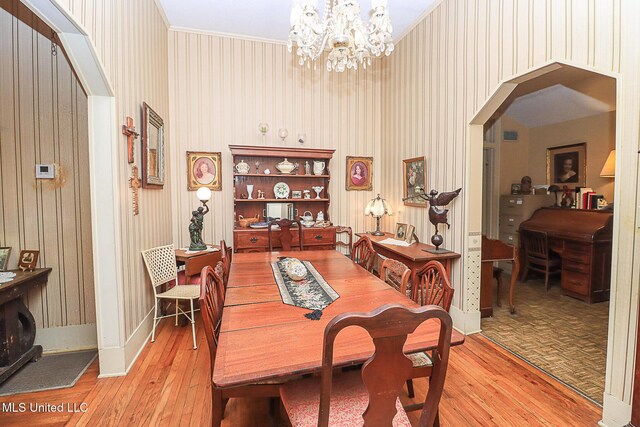 2548 Furrs Mill Dr, Wesson, MS 39191 - dining area with arched walkways, hardwood / wood-style flooring, ornamental molding, a chandelier, and baseboards