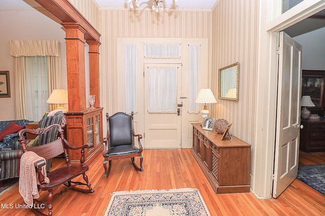 2548 Furrs Mill Dr, Wesson, MS 39191 - foyer featuring light wood-type flooring, a chandelier, decorative columns, and crown molding