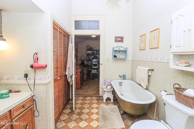 2548 Furrs Mill Dr, Wesson, MS 39191 - full bathroom with a freestanding bath, wainscoting, toilet, tile walls, and vanity