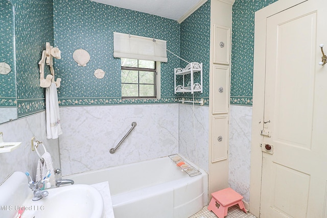 2548 Furrs Mill Dr, Wesson, MS 39191 - full bathroom with a sink, a bath, wallpapered walls, tile walls, and a wainscoted wall