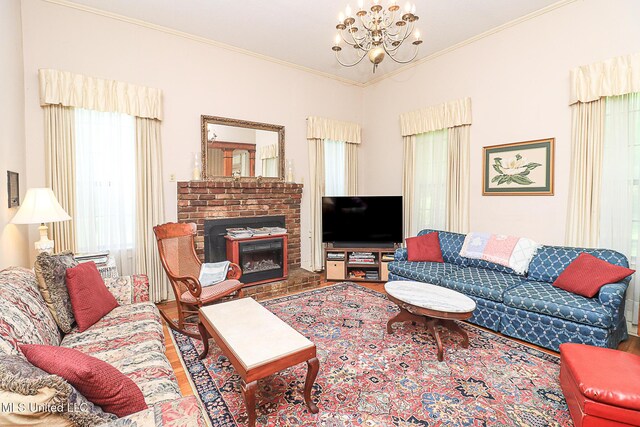 2548 Furrs Mill Dr, Wesson, MS 39191 - living area featuring a chandelier, crown molding, wood finished floors, and a brick fireplace