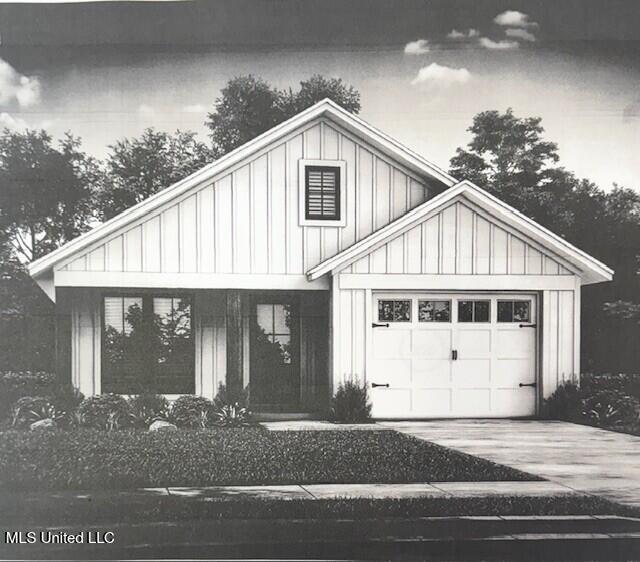 view of front facade featuring board and batten siding, driveway, and a garage