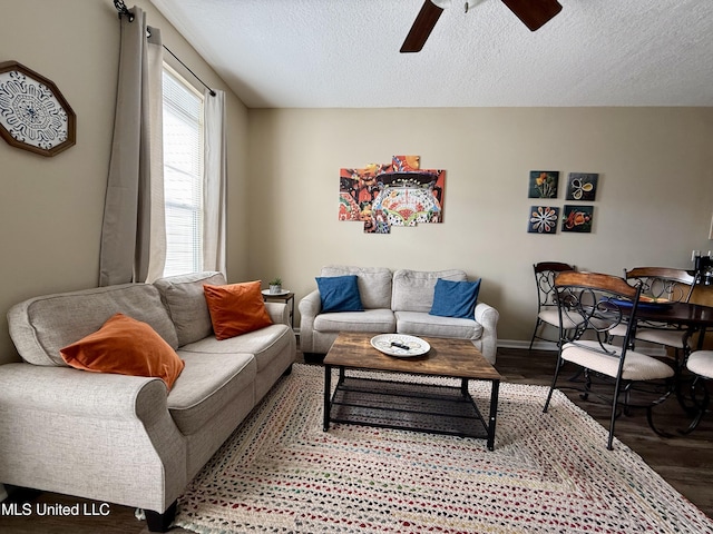 living room featuring ceiling fan, a textured ceiling, and hardwood / wood-style floors