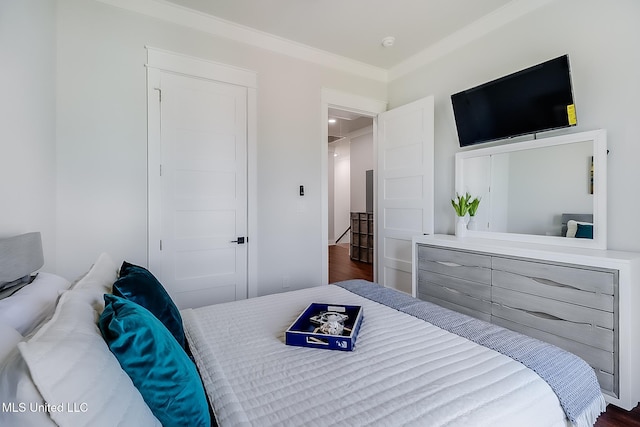 bedroom with ornamental molding and dark wood-type flooring