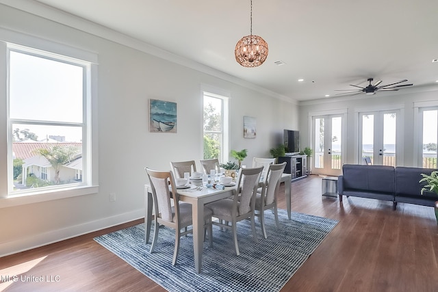 dining space featuring crown molding, dark hardwood / wood-style floors, a chandelier, and french doors