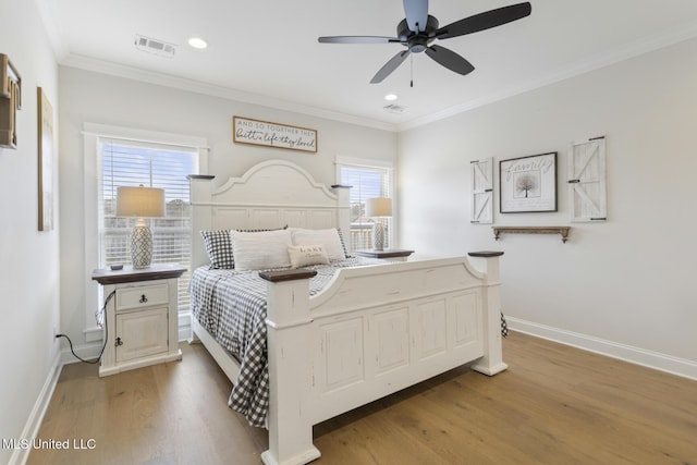 bedroom with hardwood / wood-style flooring, ceiling fan, and ornamental molding