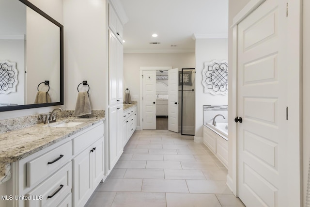 bathroom with tiled bath, crown molding, and tile patterned flooring