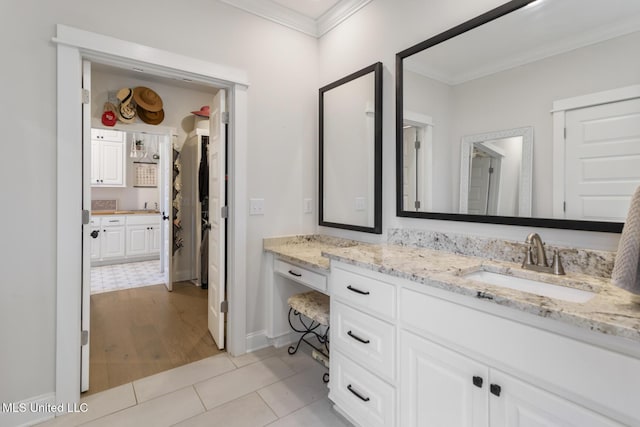 bathroom with vanity, hardwood / wood-style flooring, and crown molding