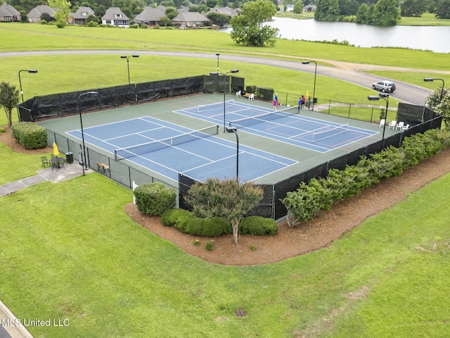 view of tennis court with a water view and basketball court