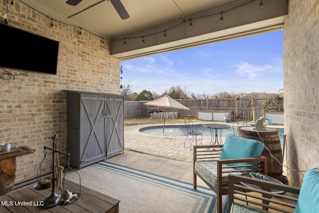 view of patio with pool water feature and ceiling fan