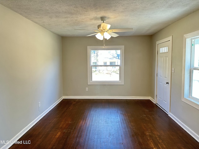 interior space featuring a textured ceiling, ceiling fan, and dark hardwood / wood-style floors