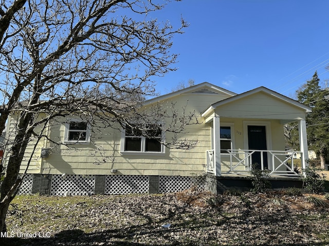 view of side of property featuring a porch