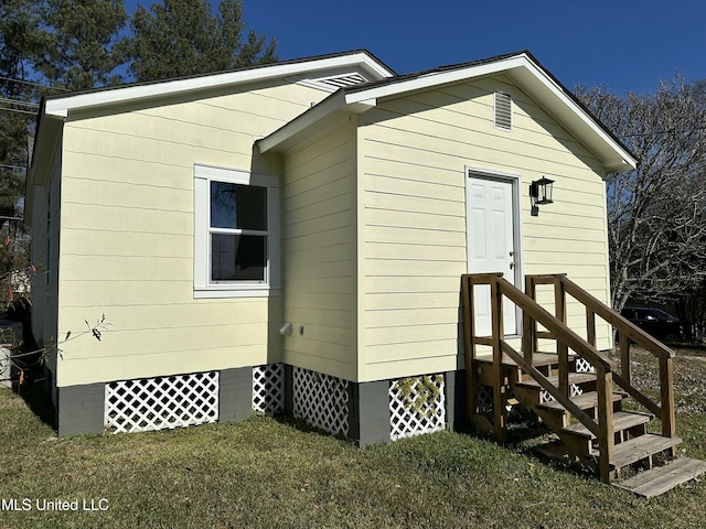 view of side of home featuring a lawn