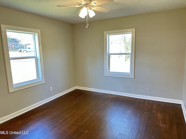 unfurnished room with ceiling fan and dark hardwood / wood-style flooring