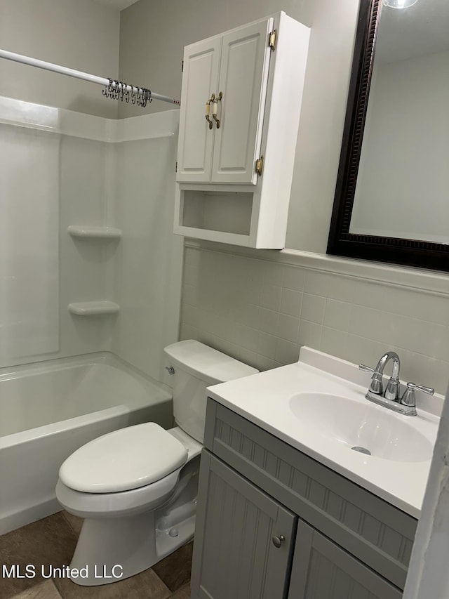 full bathroom featuring shower / bath combination, toilet, decorative backsplash, vanity, and tile walls