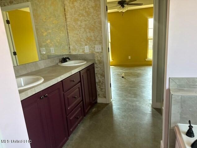 bathroom featuring baseboards, wallpapered walls, a ceiling fan, and a sink