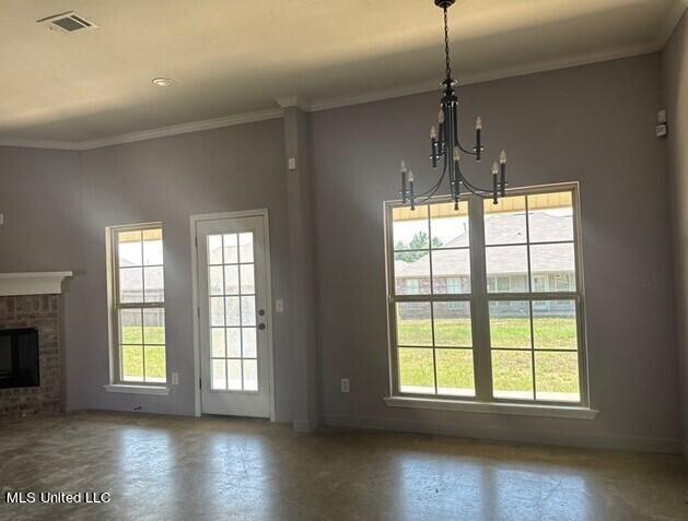 unfurnished dining area with visible vents, a healthy amount of sunlight, a chandelier, and baseboards