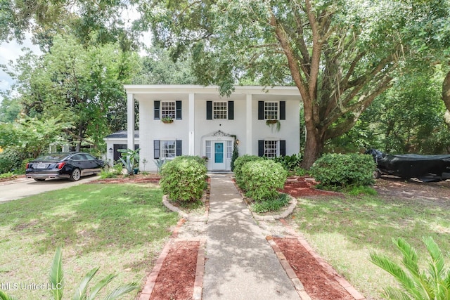 2512 Randall Dr, Biloxi, MS 39531 - greek revival house featuring stucco siding and a front lawn