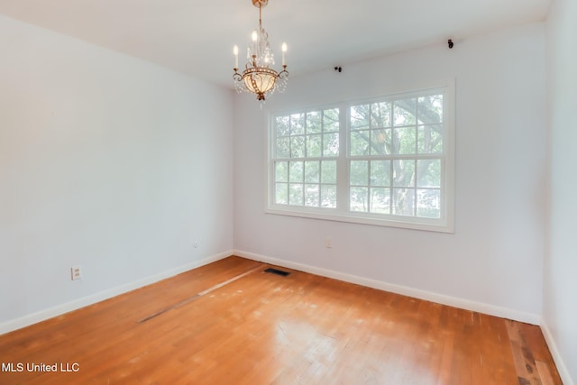 2512 Randall Dr, Biloxi, MS 39531 - unfurnished room featuring a chandelier and hardwood / wood-style floors