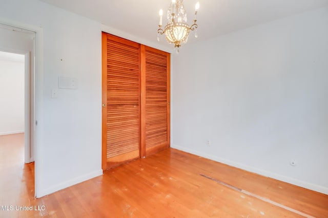 2512 Randall Dr, Biloxi, MS 39531 - unfurnished bedroom with a chandelier, light wood-style floors, and a closet