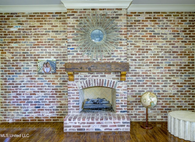 interior details with crown molding, hardwood / wood-style floors, and a brick fireplace