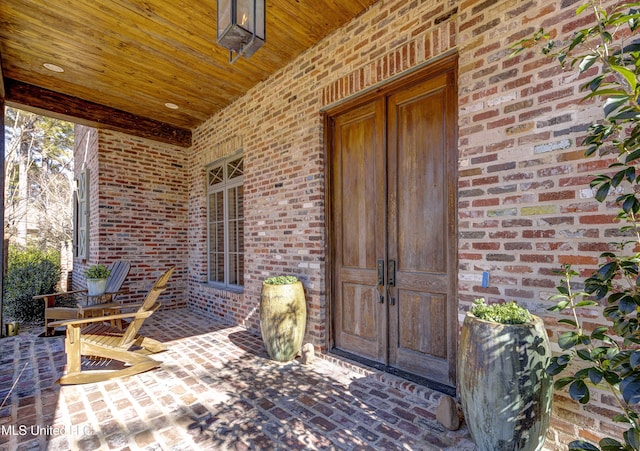 view of exterior entry featuring a porch