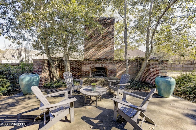 view of patio featuring an outdoor brick fireplace