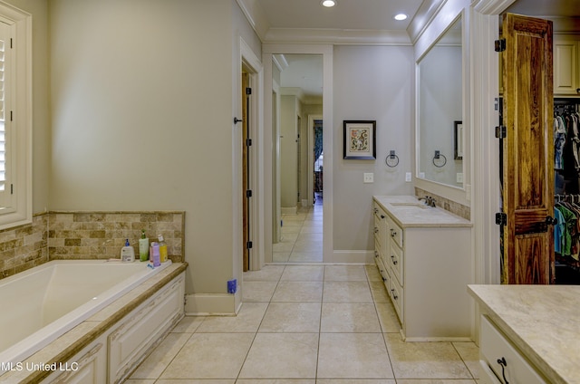 bathroom featuring vanity, a tub to relax in, tile patterned flooring, and crown molding