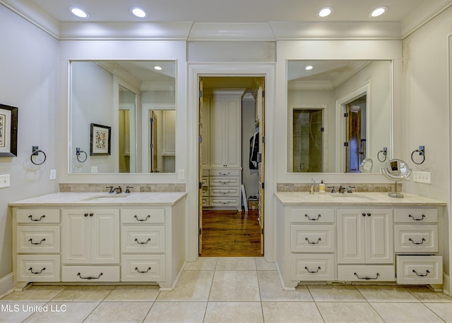 bathroom featuring tile patterned flooring, vanity, and ornamental molding