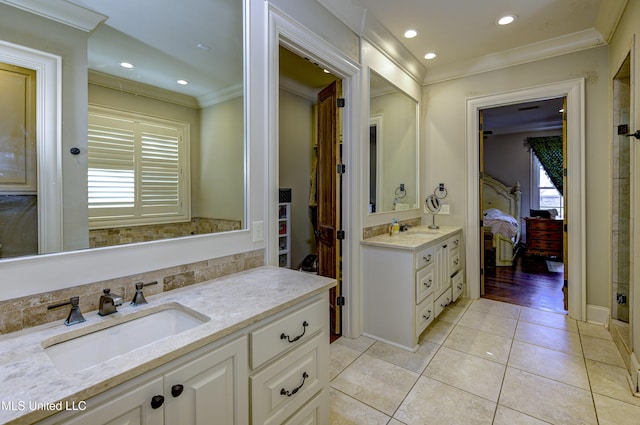 bathroom featuring vanity, tile patterned flooring, and crown molding