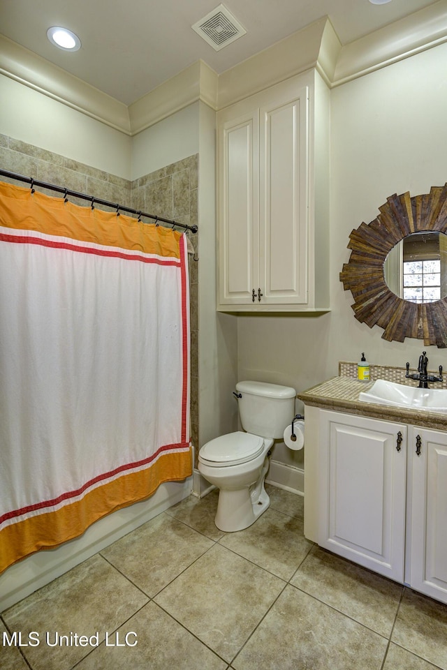 full bathroom featuring vanity, shower / tub combo with curtain, tile patterned floors, and toilet