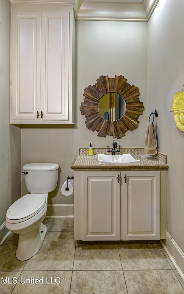 bathroom with vanity, tile patterned floors, and toilet