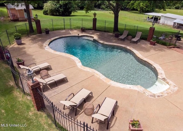 view of swimming pool featuring a yard and a patio