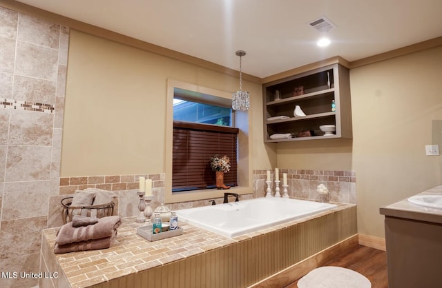 bathroom featuring hardwood / wood-style flooring, vanity, and a bathtub