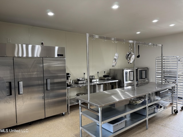 kitchen featuring built in fridge and stainless steel counters