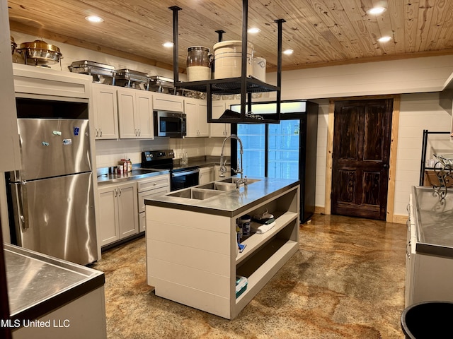 kitchen featuring stainless steel appliances, stainless steel counters, white cabinets, and an island with sink