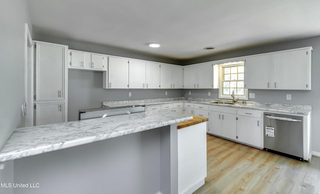 5887 Scotland Rd, Bentonia, MS 39040 - kitchen with stainless steel dishwasher, a sink, light countertops, white cabinets, and light wood finished floors
