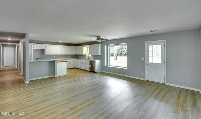 5887 Scotland Rd, Bentonia, MS 39040 - kitchen with light countertops, baseboards, dishwasher, and a sink