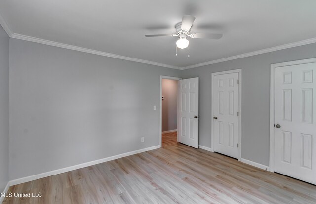 5887 Scotland Rd, Bentonia, MS 39040 - unfurnished bedroom with wood finished floors, baseboards, ornamental molding, and a ceiling fan