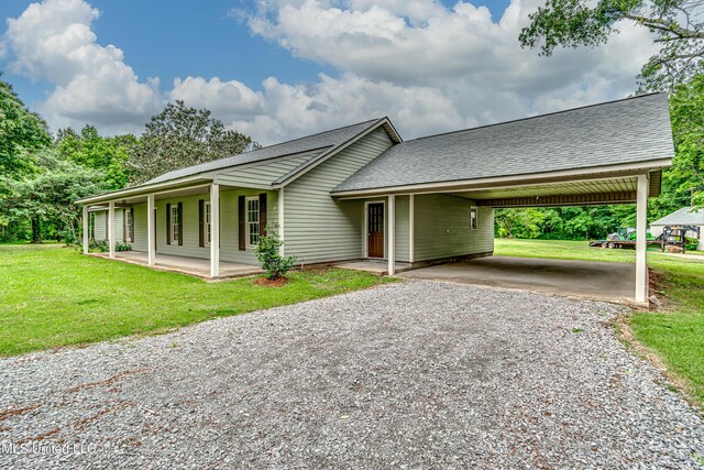 5887 Scotland Rd, Bentonia, MS 39040 - ranch-style home featuring driveway, a front lawn, an attached carport, and a shingled roof